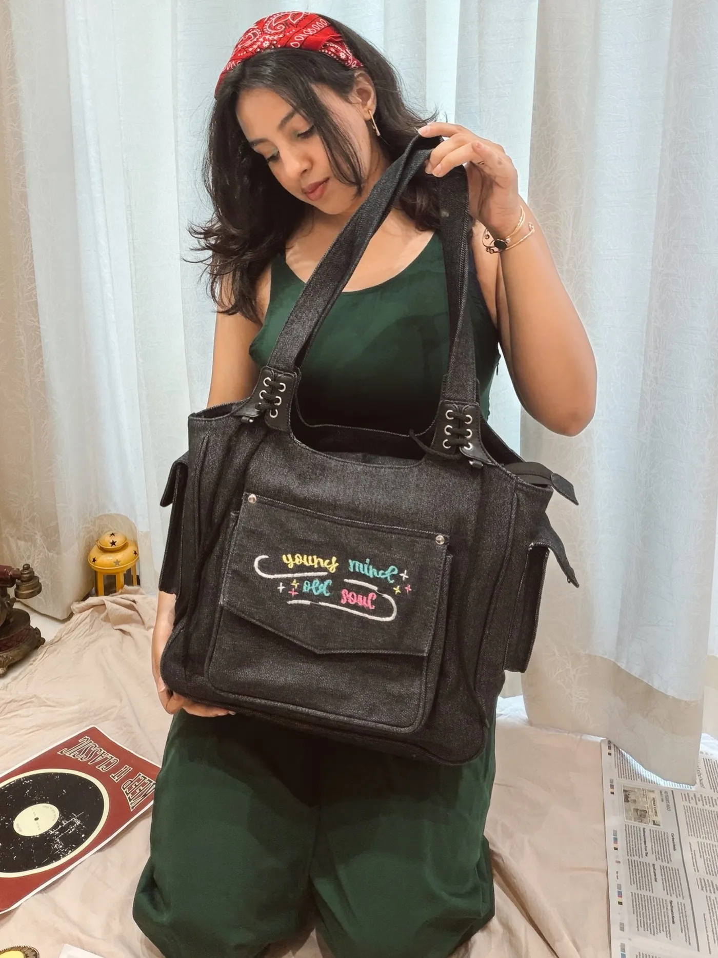 Model carrying the black denim handbag